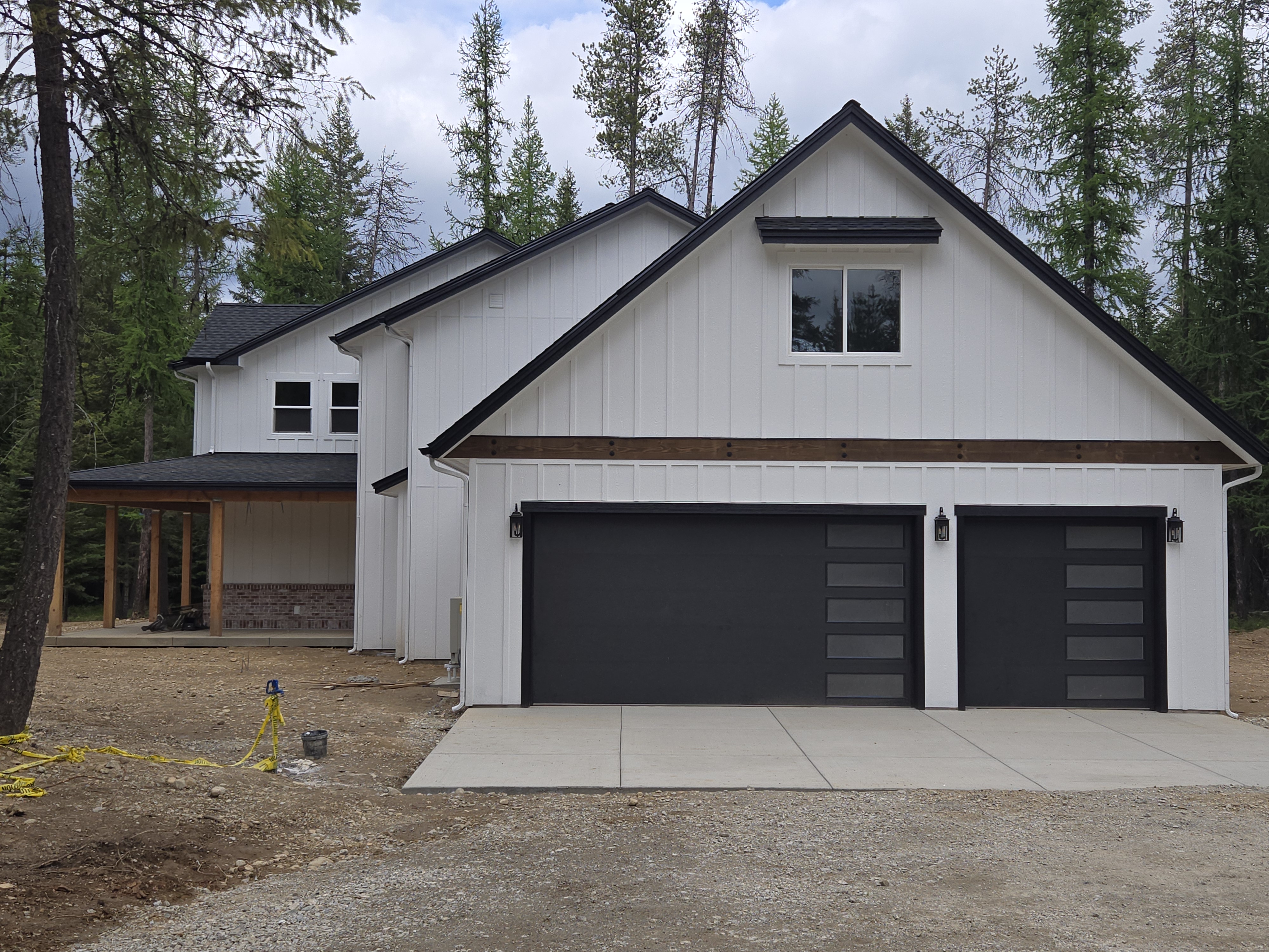 Modern custom home with three-car garage and board and batten siding