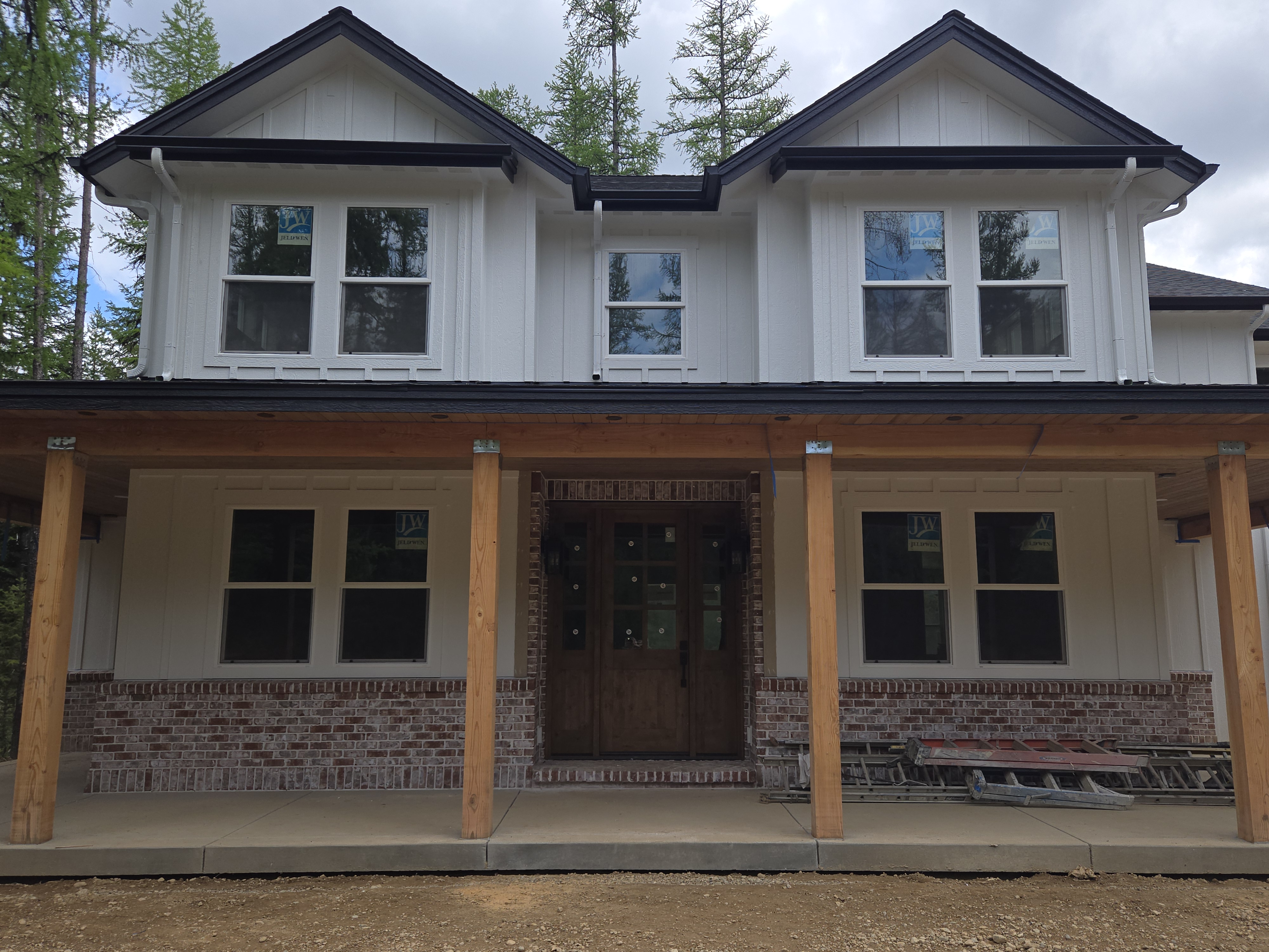 Front entrance detail showing brick wainscoting and custom front door